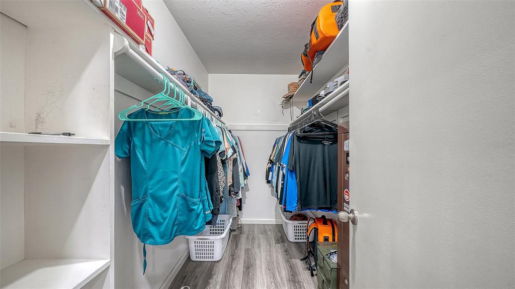 972 Leeward Road Venice, FL 34293 - Photo 16 of 27 a view of walk in closet with clothes and shoes