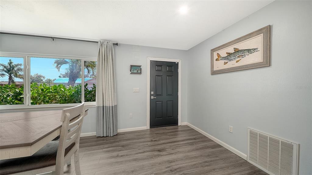 972 Leeward Road Venice, FL 34293 - Photo 4 of 27 a view of a hallway with wooden floor and windows