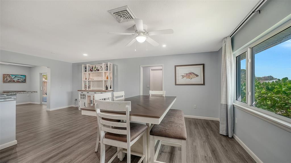 972 Leeward Road Venice, FL 34293 - Photo 6 of 27 a view of a dining room with furniture window and wooden floor