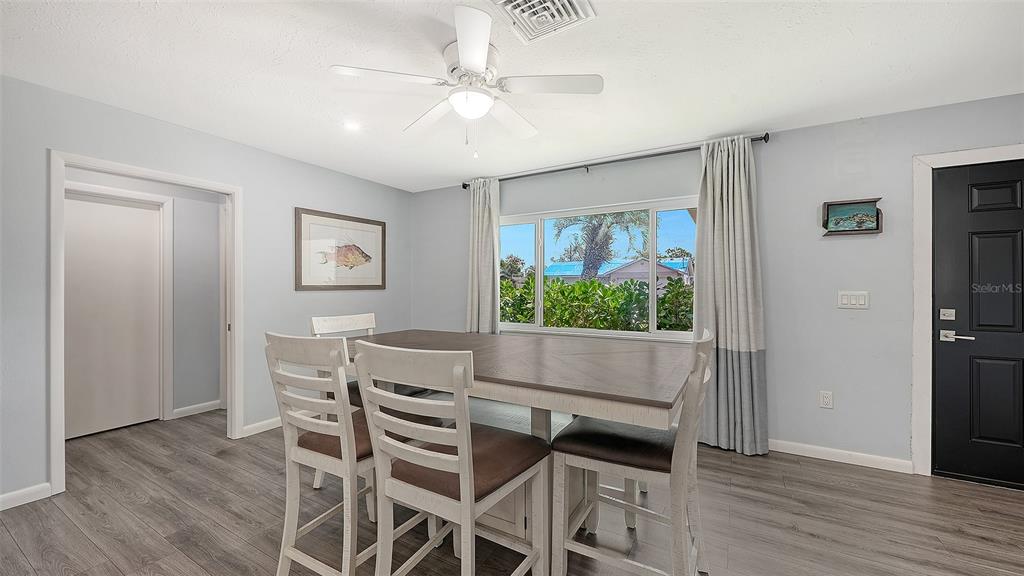 972 Leeward Road Venice, FL 34293 - Photo 7 of 27 a view of a dining room with furniture window and wooden floor