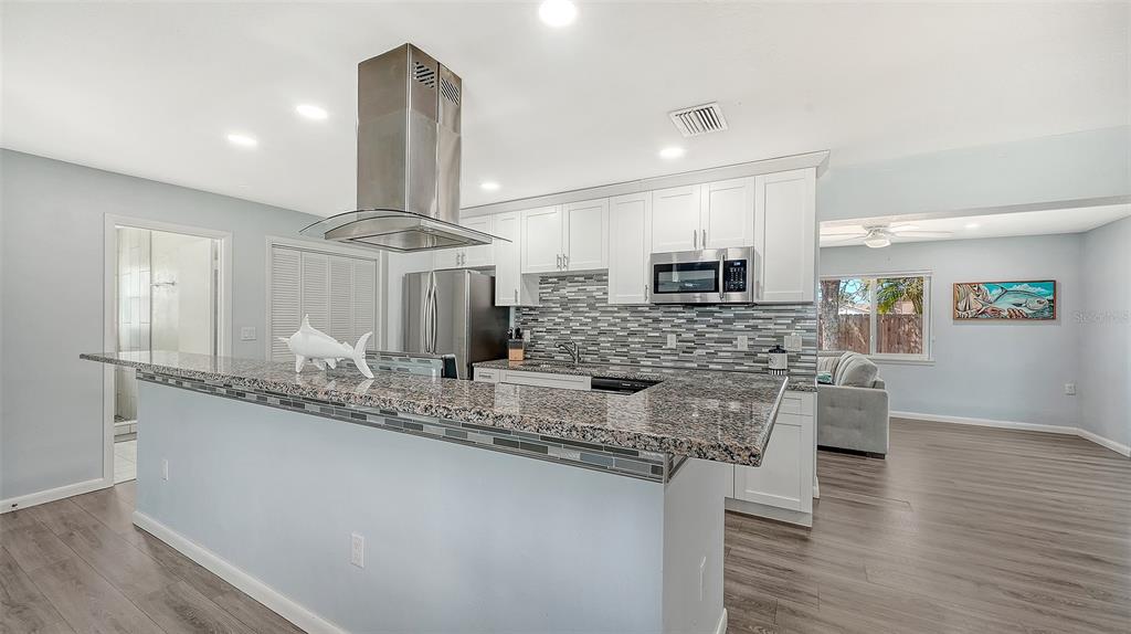 972 Leeward Road Venice, FL 34293 - Photo 8 of 27 a kitchen with stainless steel appliances granite countertop a sink and stove