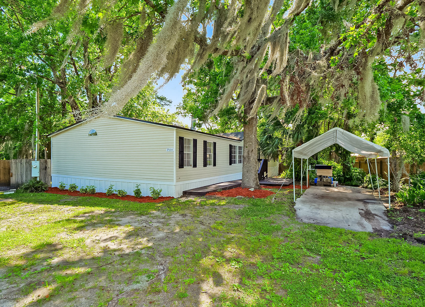 a backyard of a house with table and chairs