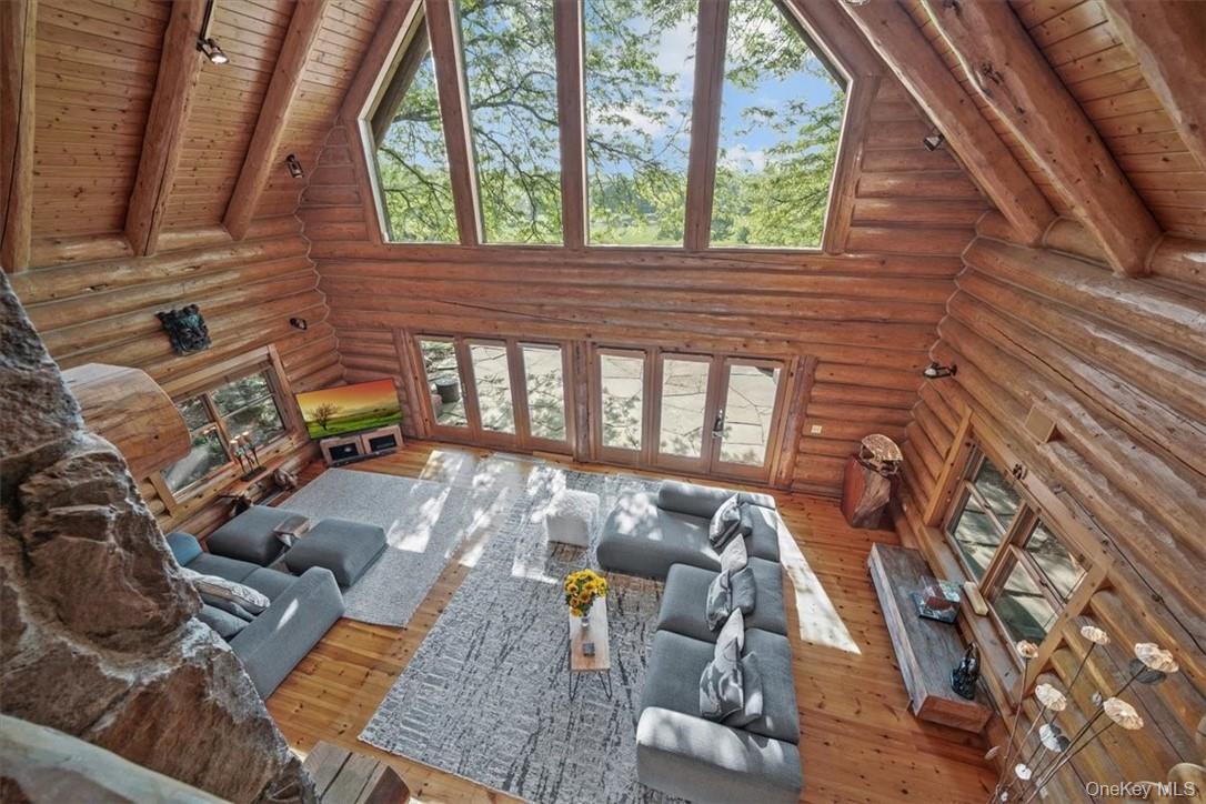 101 Mountain Lodge Road Washingtonville, NY 10992 - Photo 5 of 26 Great room with magnificent westerly views, walls of windows and cathedral ceiling. There is in-house sound, under ground electric, a whole house generator, and owned propane tanks.