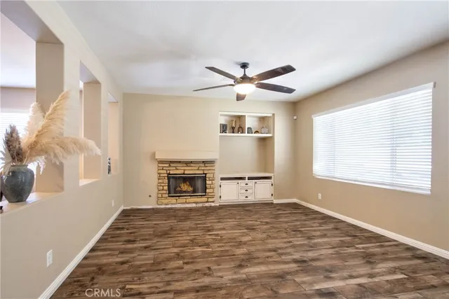 a view of a livingroom with a ceiling fan and window