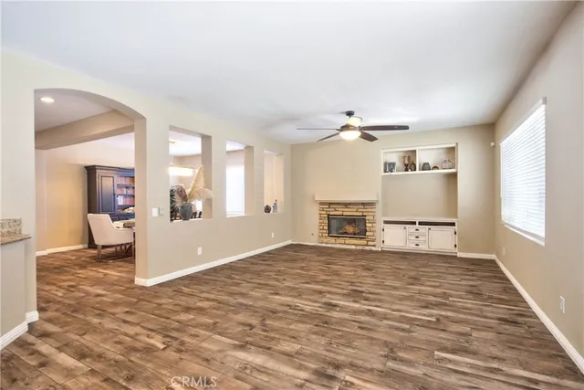 a view of a livingroom with a ceiling fan and window
