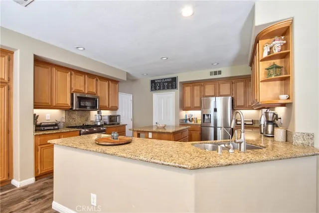 a kitchen with granite countertop a sink and a counter top space
