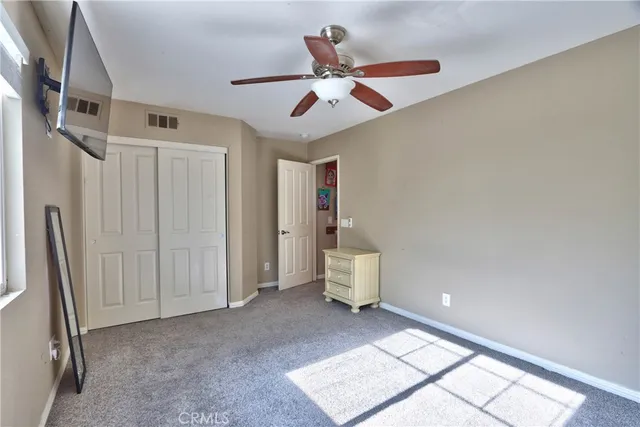 a view of an empty room and a ceiling fan