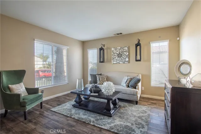 a living room with furniture and wooden floor