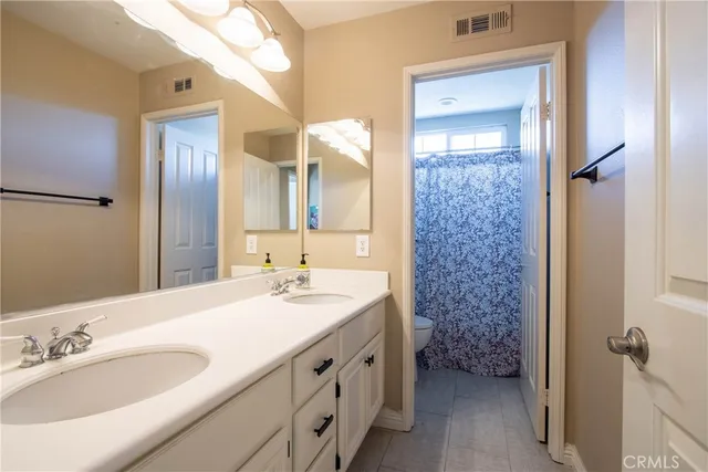 a bathroom with a sink a vanity and a mirror