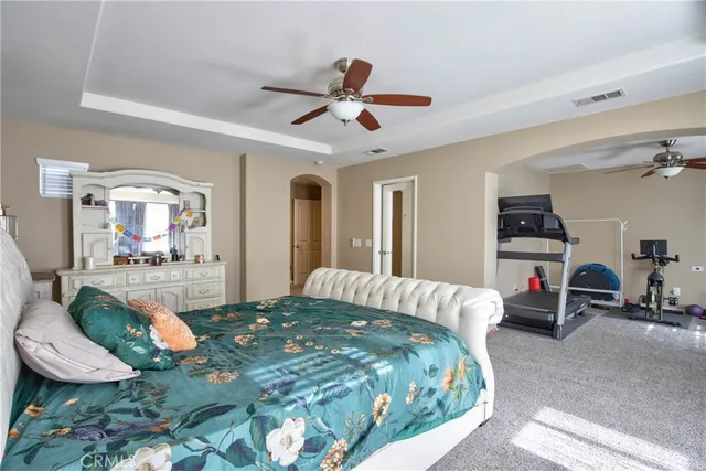 a bedroom with bed and a chandelier