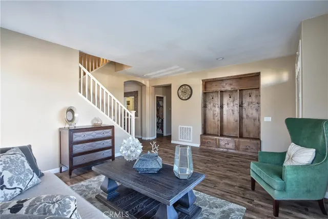 a living room with furniture and a stairs
