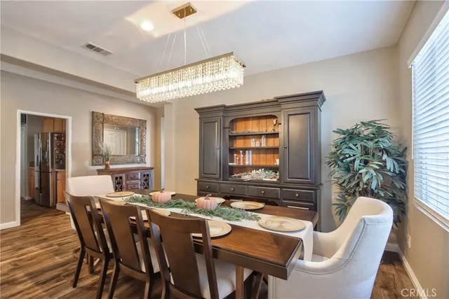 a view of a a dining room with furniture window and wooden floor