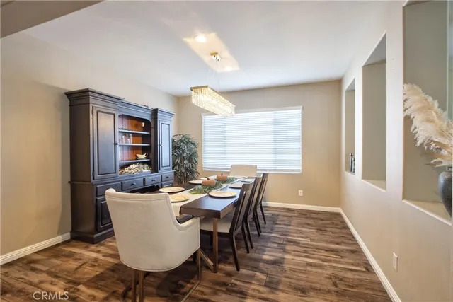 a dining room with furniture a rug and wooden floor