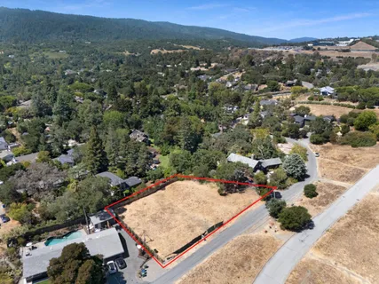 an aerial view of residential houses with outdoor space and seating