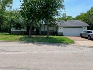 100 2nd Street Glen Rose, TX 76043 - Photo 1 of 11 front view of a house with a yard and trees