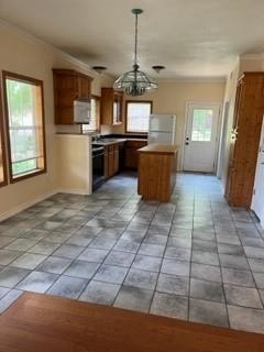 100 2nd Street Glen Rose, TX 76043 - Photo 3 of 11 a kitchen with stainless steel appliances granite countertop a stove a sink a microwave a refrigerator and cabinets