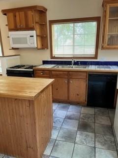 100 2nd Street Glen Rose, TX 76043 - Photo 5 of 11 a kitchen with a stove a sink and a microwave