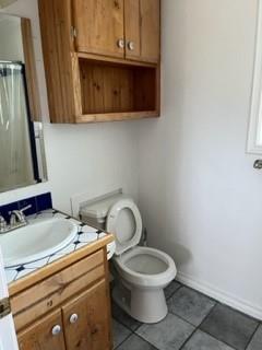 100 2nd Street Glen Rose, TX 76043 - Photo 9 of 11 a bathroom with a toilet sink and mirror