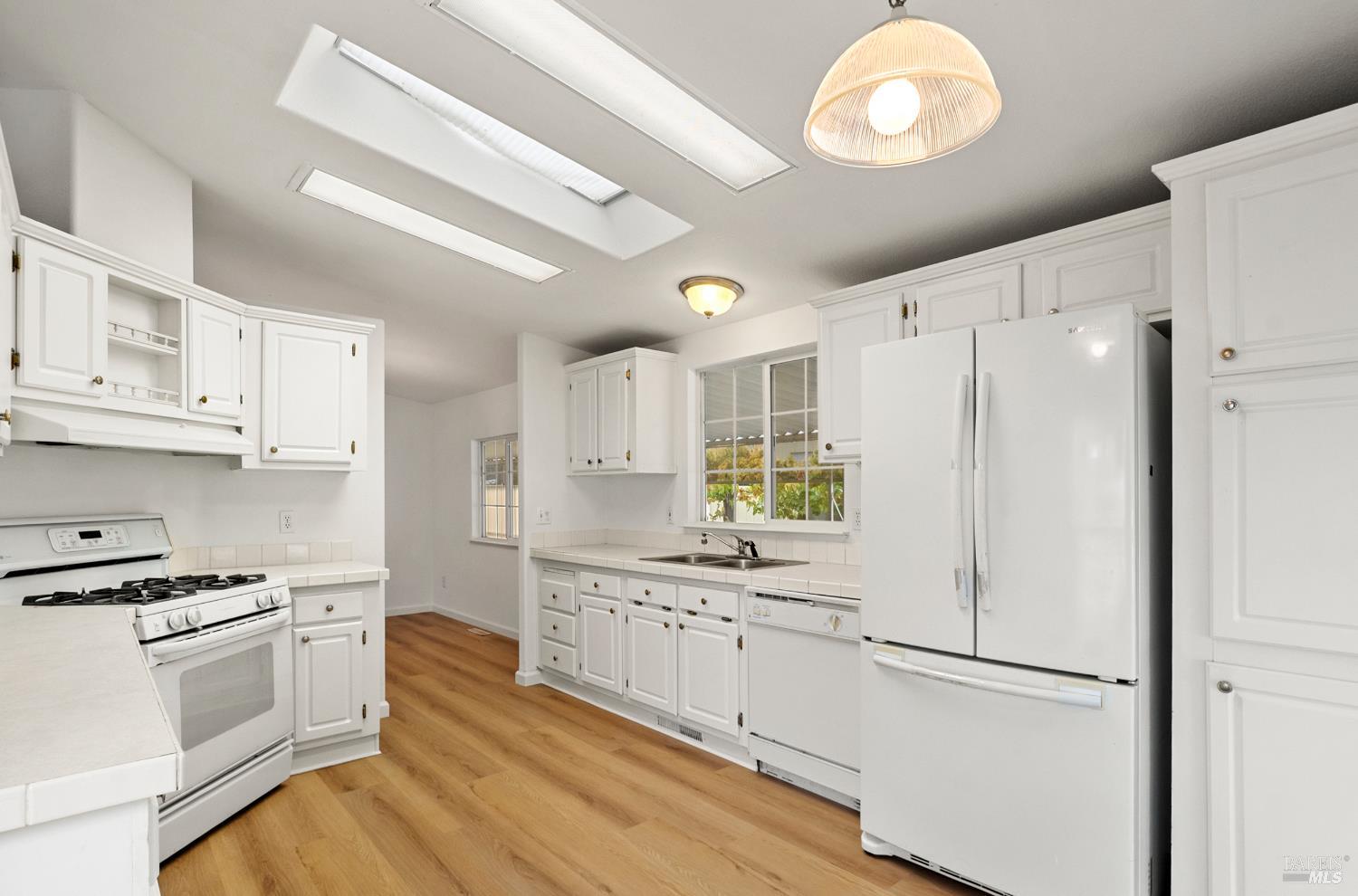 2412 Foothill Boulevard, Unit 41 Calistoga, CA 94515 - Photo 12 of 33 a kitchen with white cabinets and white appliances