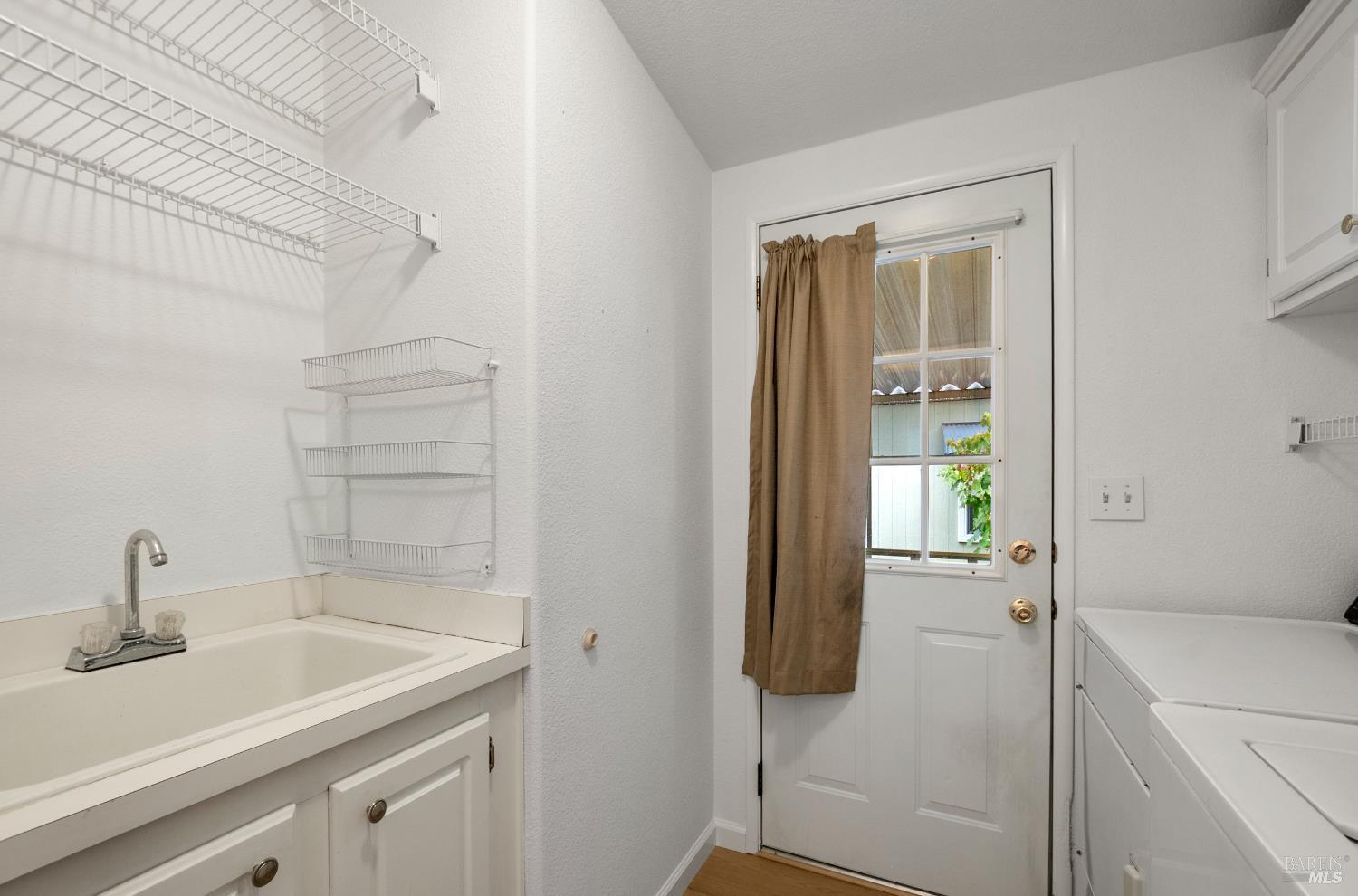 2412 Foothill Boulevard, Unit 41 Calistoga, CA 94515 - Photo 21 of 33 a bathroom with a sink and mirror with toilet