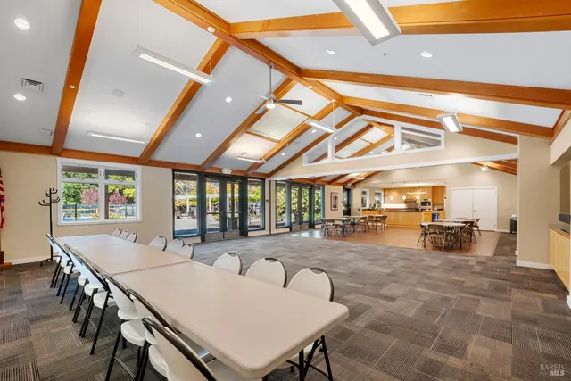 a view of a dining room with furniture and a chandelier