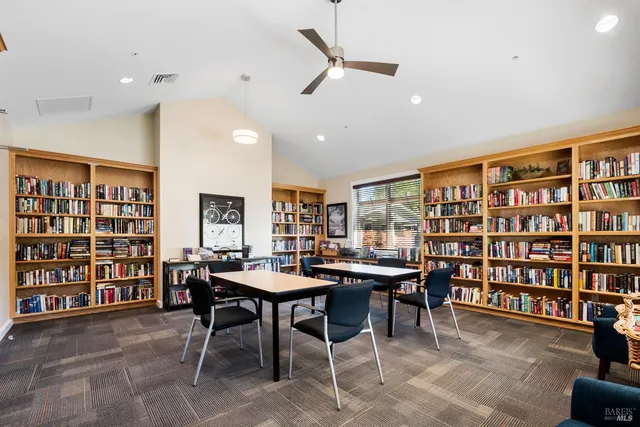 a view of a livingroom with furniture and a bookshelf