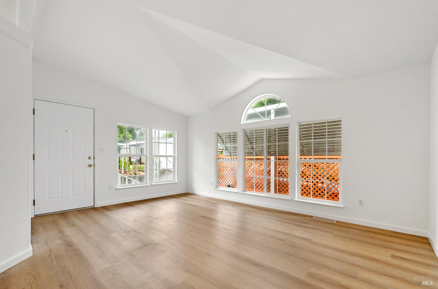 2412 Foothill Boulevard, Unit 41 Calistoga, CA 94515 - Photo 5 of 33 an empty room with wooden floor and windows