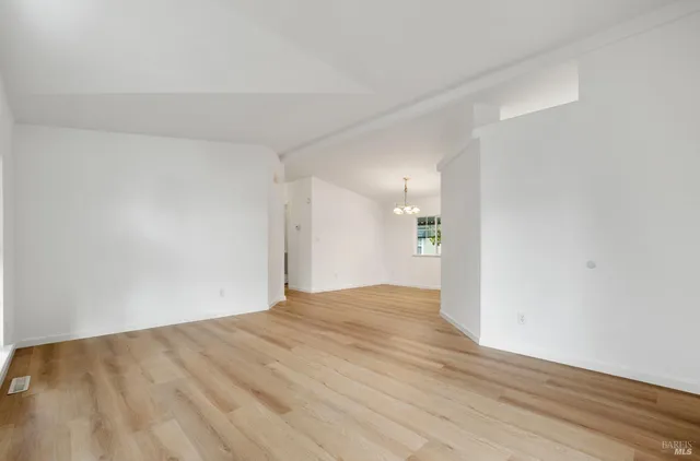 a view of an empty room and wooden floor