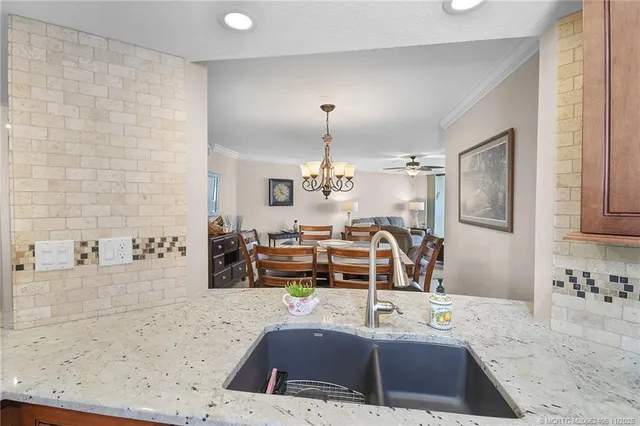 a kitchen with stainless steel appliances a stove a sink and a refrigerator