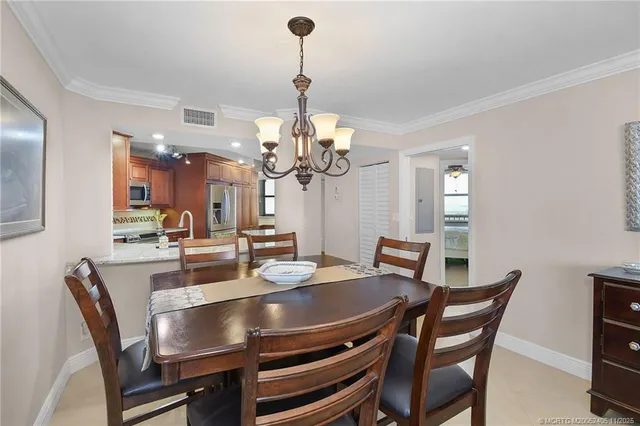 a kitchen with stainless steel appliances granite countertop a refrigerator a sink dishwasher a stove with wooden cabinets and floor