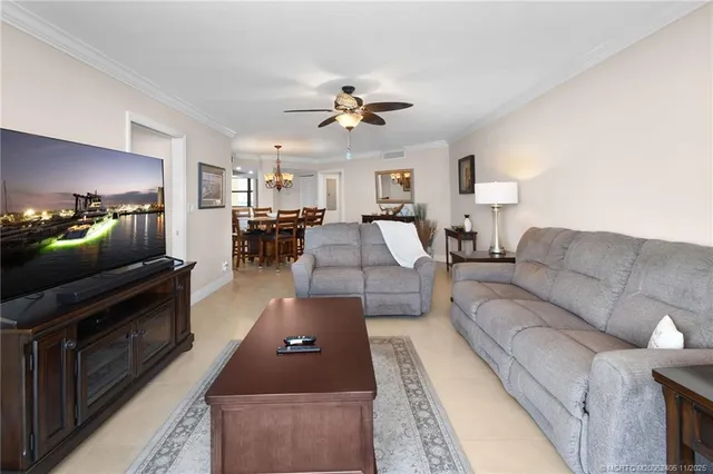 a spacious bedroom with a bed and a chandelier