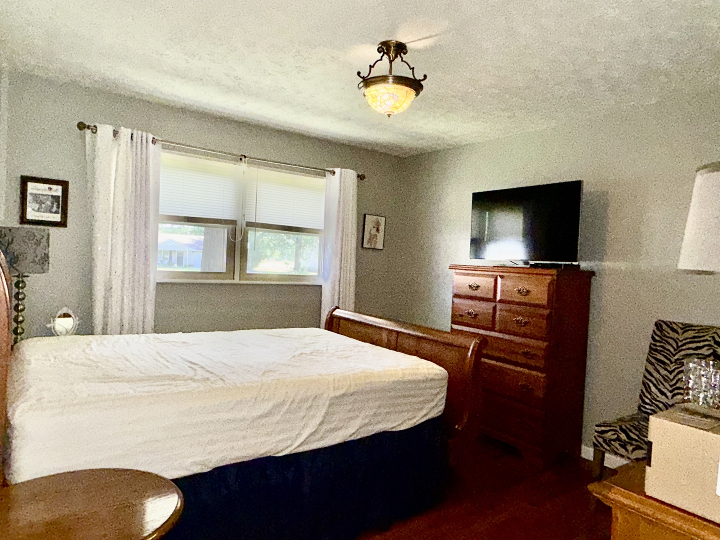 956 Country Club Road Metropolis, IL 62960 - Photo 20 of 48 a bedroom with a bed and a flat screen tv