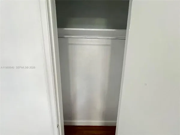 a view of a chair and table in backyard of the house