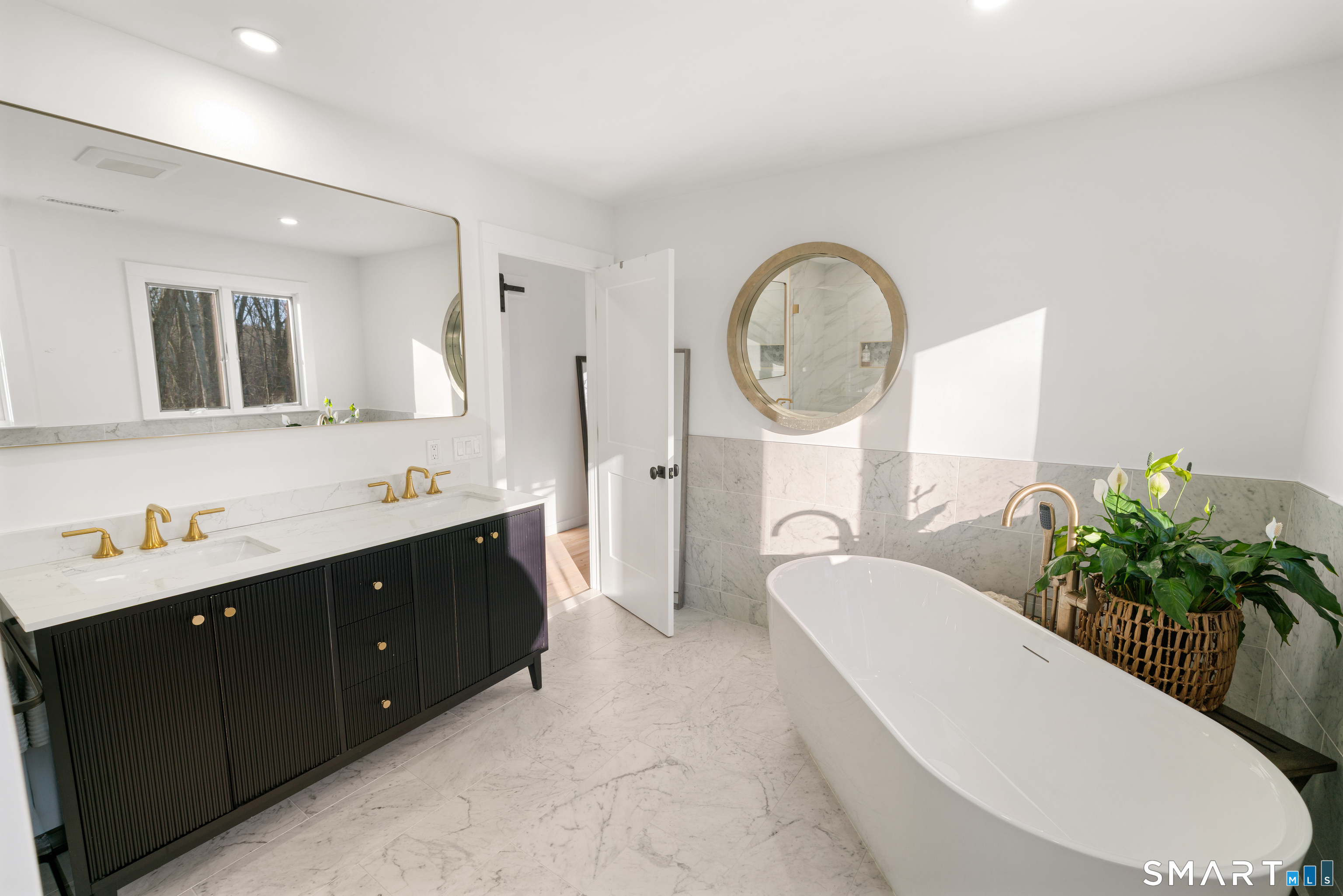 23 Norton Road Easton, CT 06612 - Photo 23 of 40 The primary bath offers a soaking tub and double vanity, creating a serene, spa inspired retreat.