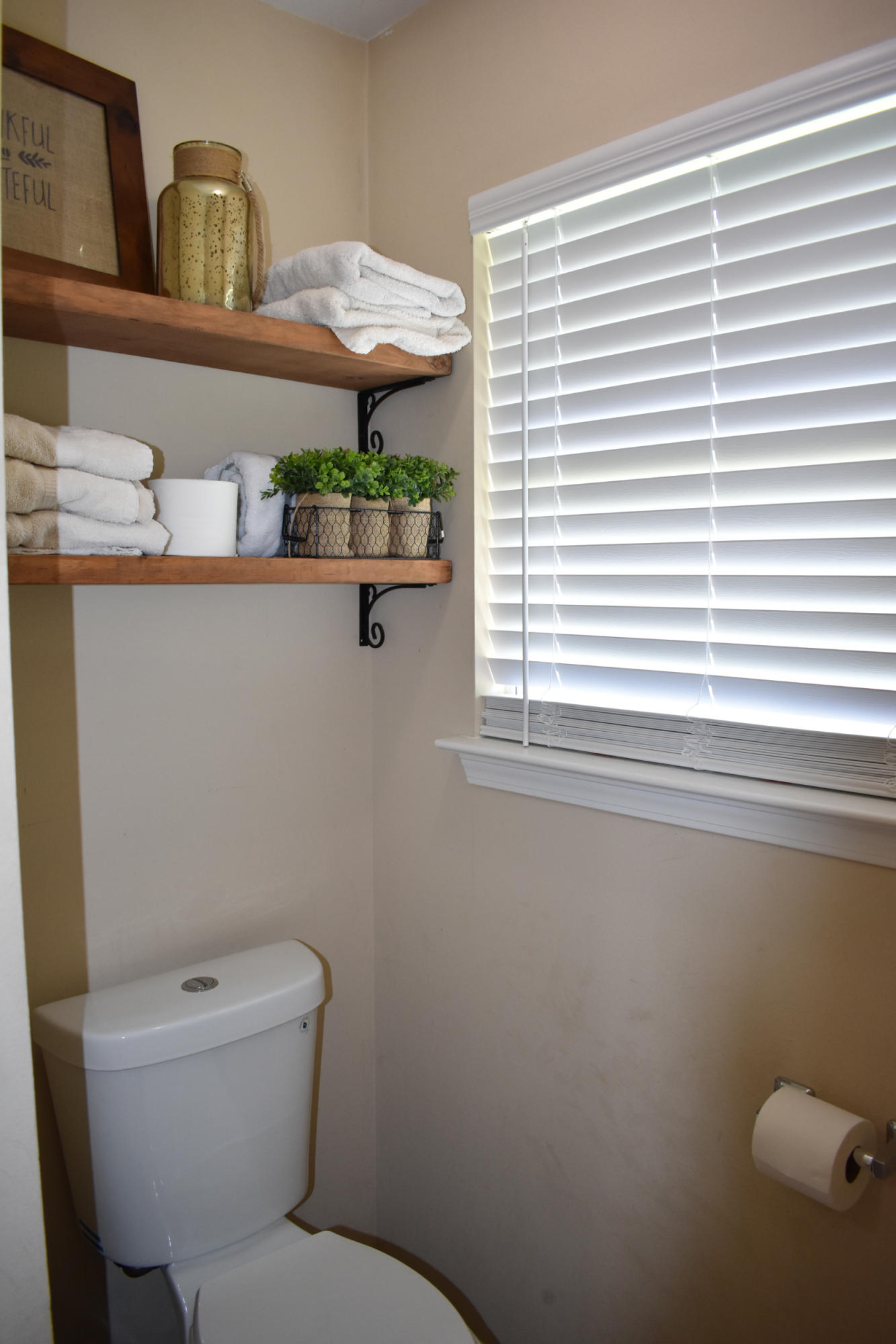6616 Old River Road Baker, FL 32531 - Photo 7 of 19 a bathroom with a toilet a sink and a window