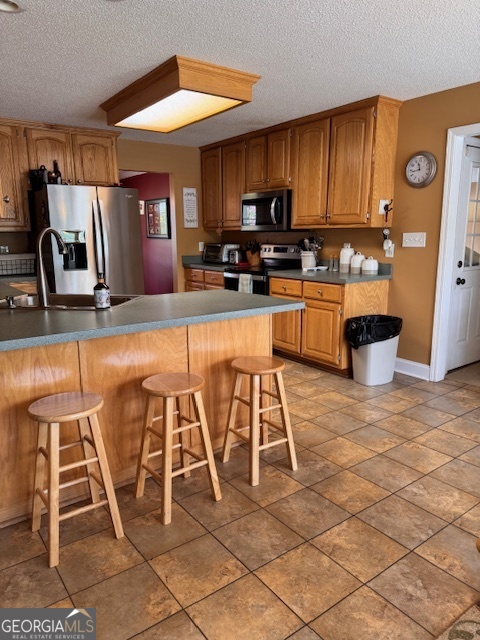 495 Hanley Road Hull, GA 30646 - Photo 13 of 36 a kitchen with stainless steel appliances kitchen island granite countertop a stove a sink and a microwave