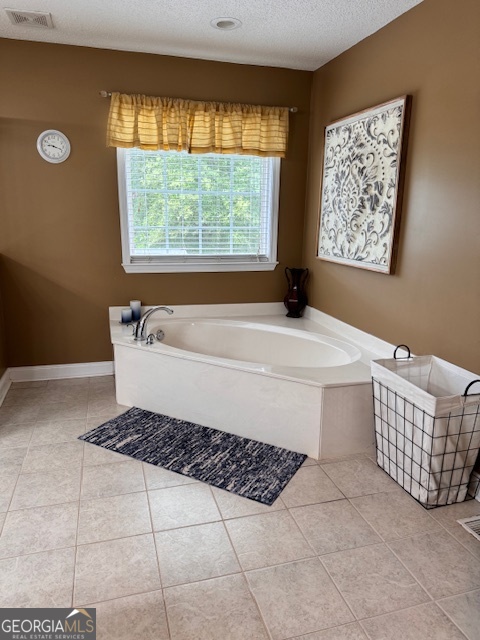495 Hanley Road Hull, GA 30646 - Photo 20 of 36 a bathroom with a bathtub and window