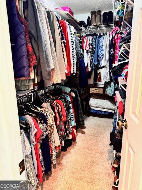 495 Hanley Road Hull, GA 30646 - Photo 22 of 36 a view of walk in closet with clothes and shoes