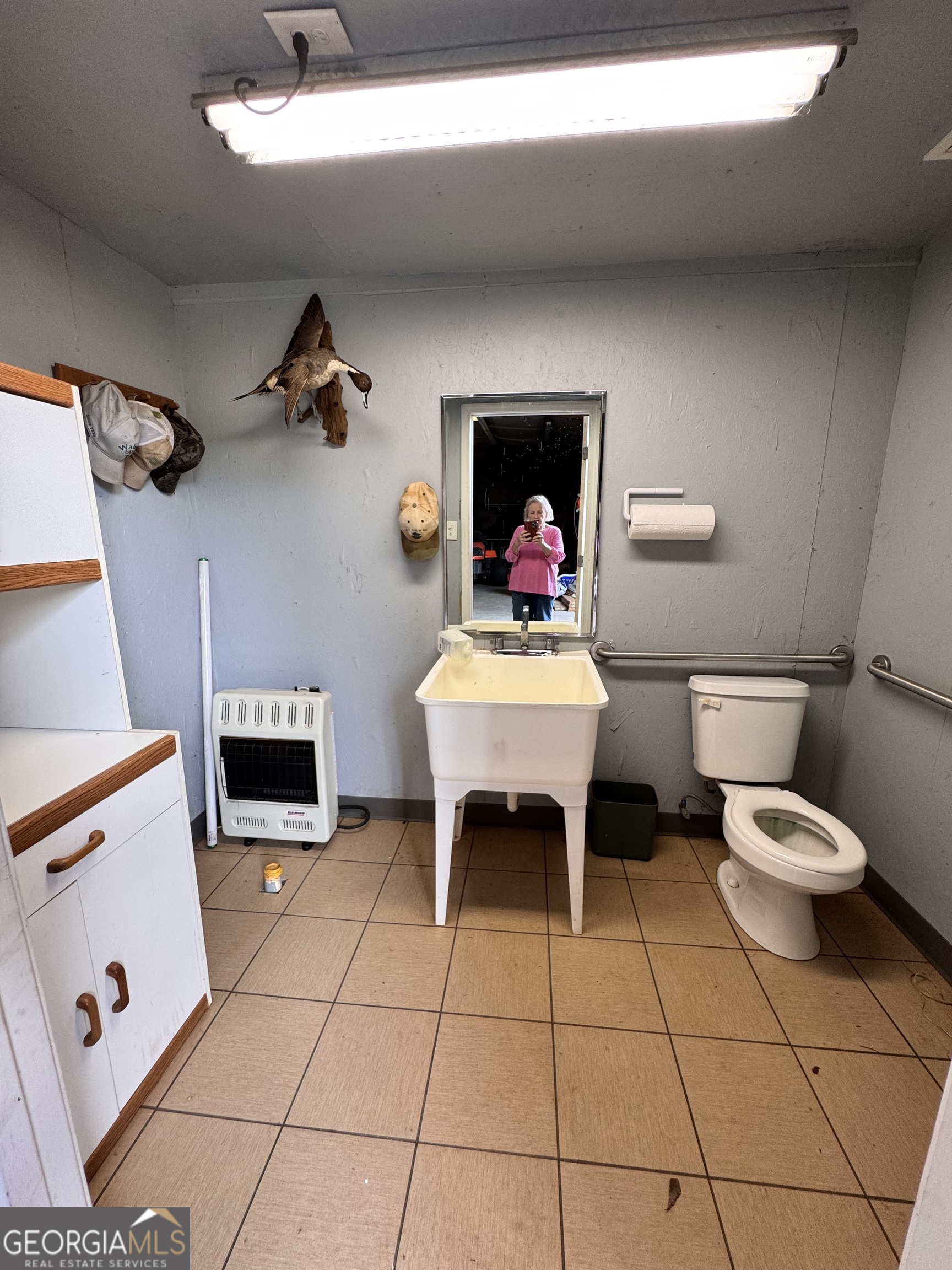 495 Hanley Road Hull, GA 30646 - Photo 34 of 36 a living room with a baby crib furniture and a fireplace