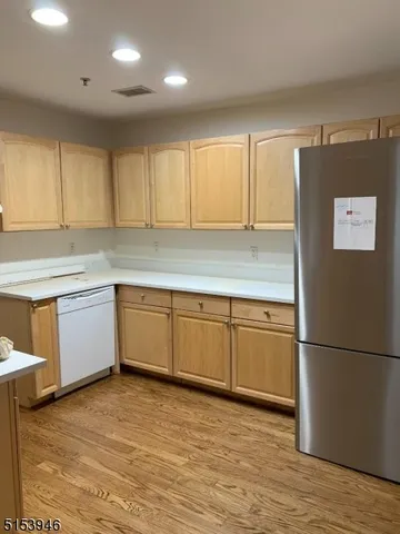 a kitchen with stainless steel appliances granite countertop a refrigerator sink and cabinets