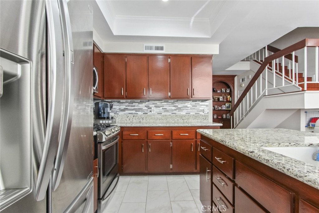 4655 Natick Avenue, Unit 3 Sherman Oaks, CA 91403 - Photo 11 of 25 a kitchen with stainless steel appliances granite countertop a sink stove and refrigerator