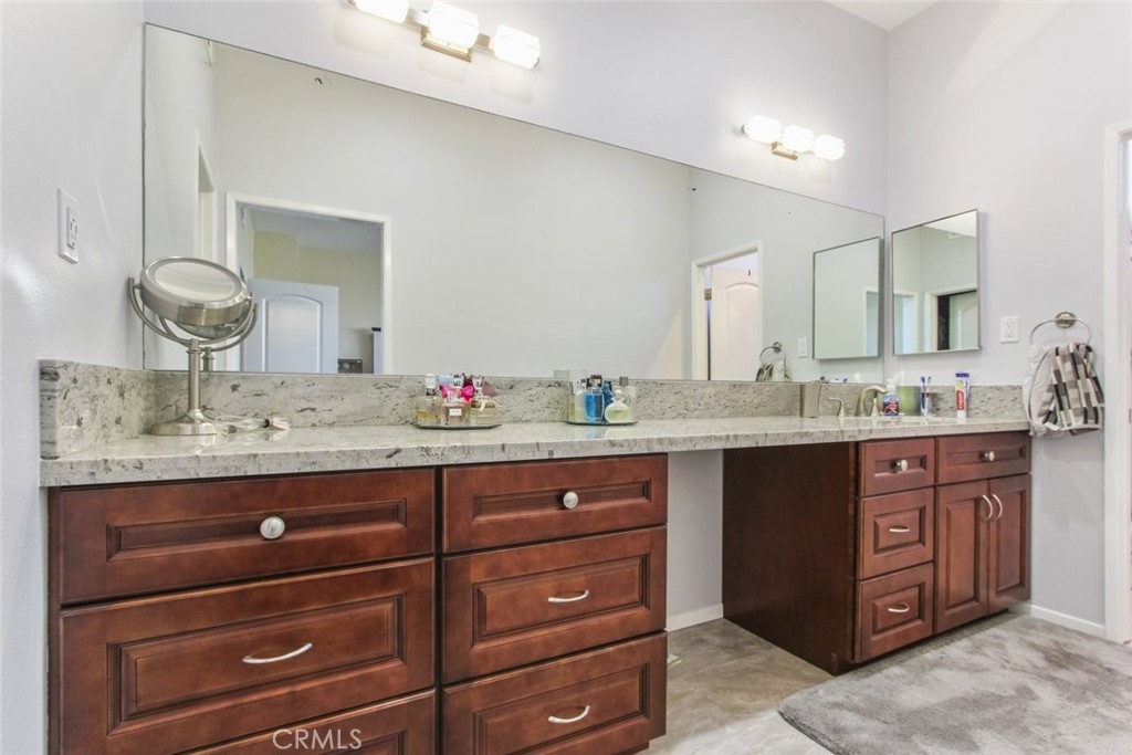 4655 Natick Avenue, Unit 3 Sherman Oaks, CA 91403 - Photo 15 of 25 a bathroom with a granite countertop sink and a mirror
