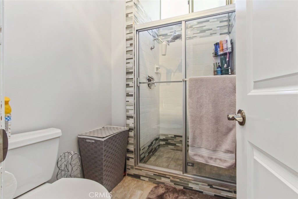 4655 Natick Avenue, Unit 3 Sherman Oaks, CA 91403 - Photo 16 of 25 a bathroom with a granite countertop sink mirror vanity and toilet