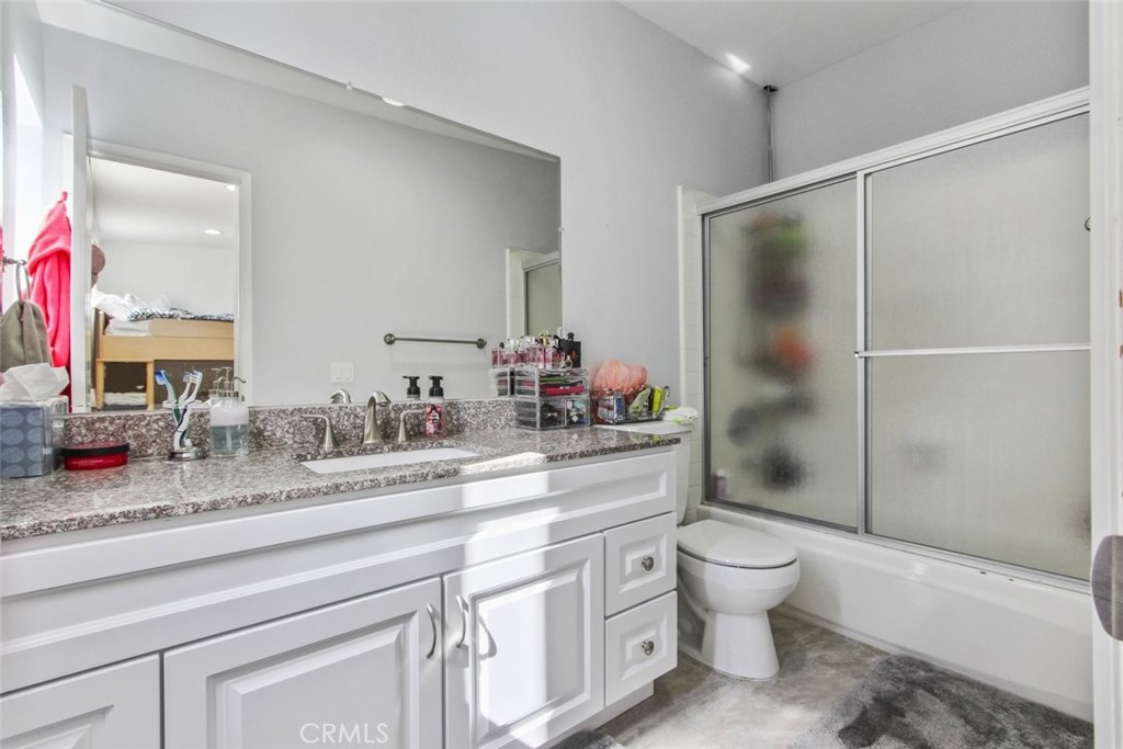 4655 Natick Avenue, Unit 3 Sherman Oaks, CA 91403 - Photo 20 of 25 a bathroom with a granite countertop sink toilet and shower