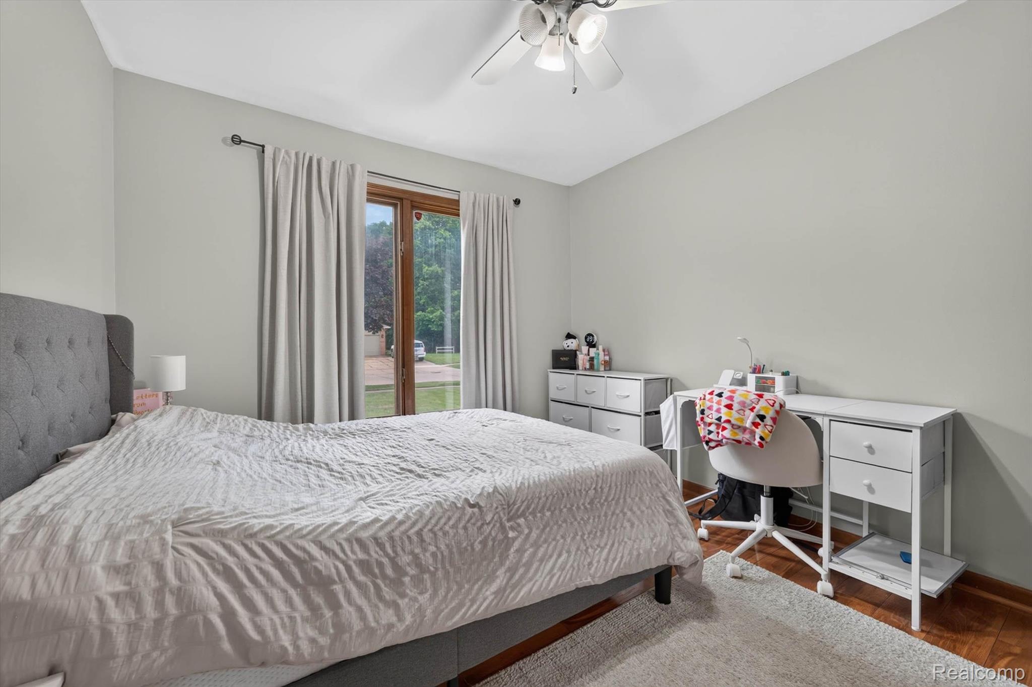 46362 Springhill Drive Utica, MI 48317 - Photo 22 of 59 Room featuring wood-finish flooring, light grey painted walls, and a ceiling fan with integrated lighting