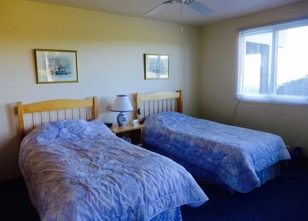 a bedroom with bed and window