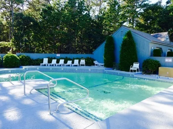 a view of house with backyard and sitting area