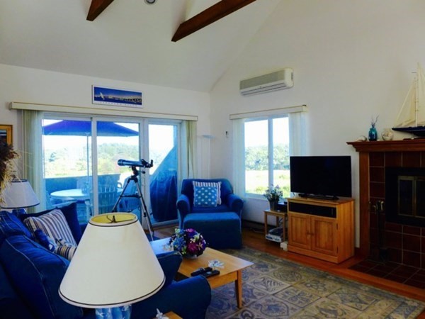 40 Hidden Cove Road Oak Bluffs, MA 02557 - Photo 3 of 20 a living room with furniture a flat screen tv and a window