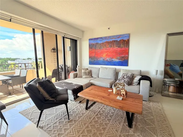 a living room with furniture and large windows
