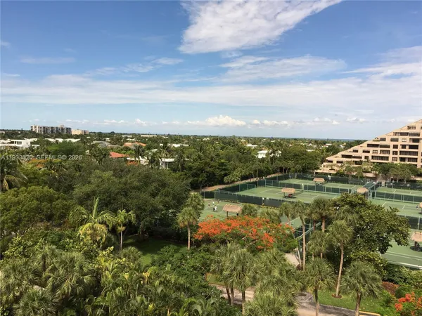 a view of a lake with houses in back